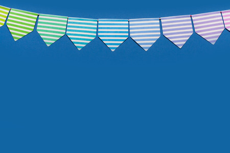 Colored flags garland. The background is blue. celebration
