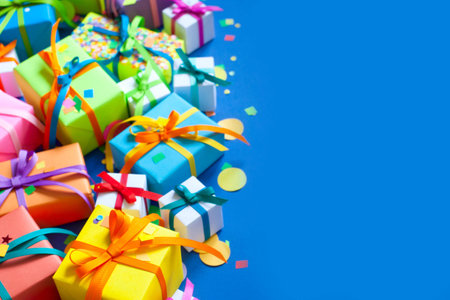 Many colored gifts lie and stand on a blue background.の写真素材