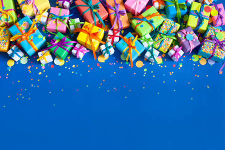 Many colored gifts lie and stand on a blue background.の写真素材