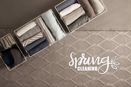 Spring cleaning of closet. Vertical tidying up storage. Neatly folded clothes in the metal white...