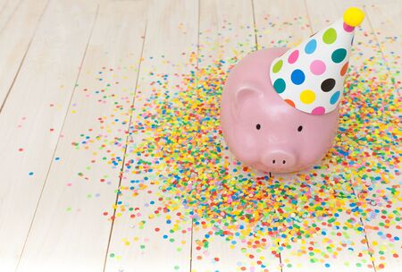 A pink piggy bank in glasses at a party.の写真素材