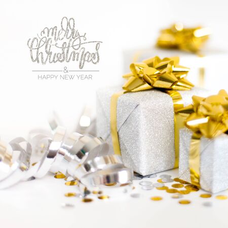 Christmas silver and gold gift box with decoration on white backgroundの写真素材