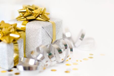 Christmas banner. Xmas silver gifts box with gold bows, white background. Horizontal poster,...