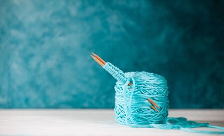 Knitting project in progress. A piece of knitting with ball of yarn and a knitting needles.の写真素材