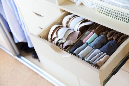 Large wardrobe with different clothes, home stuff and shoesの写真素材