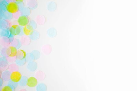 Confetti scattered in different colors on a white background. Festive confetti. The decor for the party.の写真素材