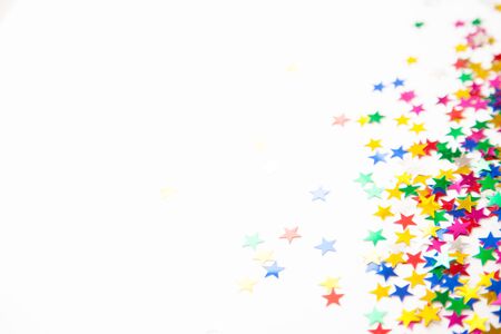 Confetti scattered in different colors on a white background. Festive confetti. The decor for the party.の写真素材