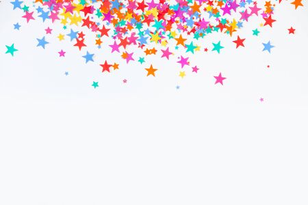 Confetti scattered in different colors on a white background. Festive confetti. The decor for the party.の写真素材