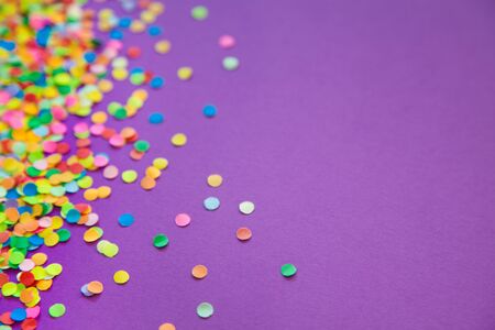 Round frame made of colored confetti. White background. Festive confetti.