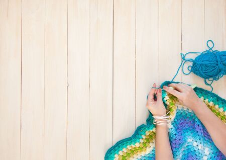 Color thread for knitting, knitted scarf, knitting needles on a dark background. Copy space. Knitting conceptの写真素材