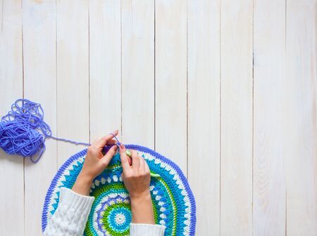 Color thread for knitting, knitted scarf, knitting needles on a dark background. Copy space. Knitting conceptの写真素材