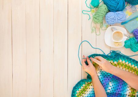 Female hands knitting with color wool, top viewの写真素材
