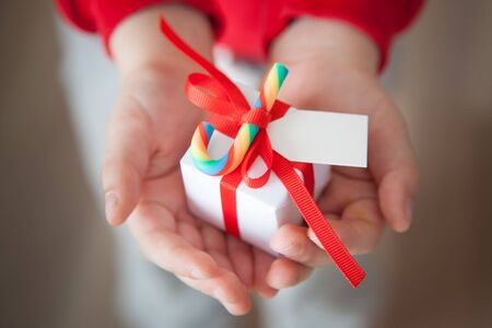 Close-up of gift box on hands of a boyの写真素材
