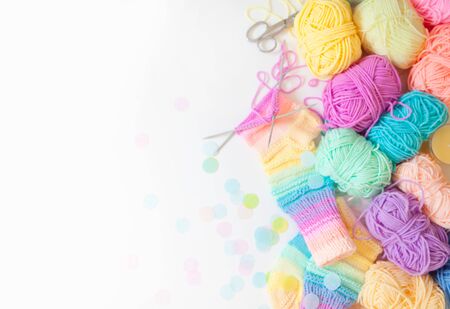 Knitted wool colored, rainbow striped socks. Skeins of yarn for knitting.の写真素材