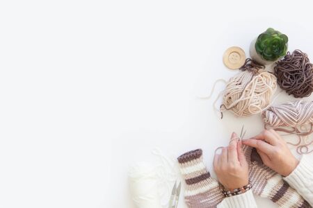 Yarn in a basket of beige and neutral, natural tones, knitting and crocheting. Spokes, succulent, scissors. White background.の写真素材
