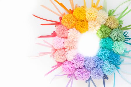 Pompons of colored yarn. White background. Bright colours.