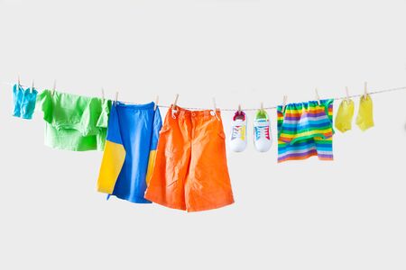 Baby and children clothes hanging on the clothesline.の写真素材