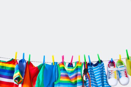 Baby and children clothes hanging on the clothesline.の写真素材