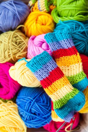 Bright colored yarn for knitting in a basket.の写真素材