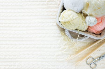 Yarn in a basket of beige and neutral, natural tones, knitting and crocheting. Spokes, succulent,...