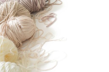 Wool and cotton yarn for knitting of neutral natural color. Background white.