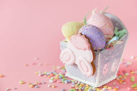Russian Orthodox Easter. White and pink background. Easter cake, Easter bunny, colored eggs.