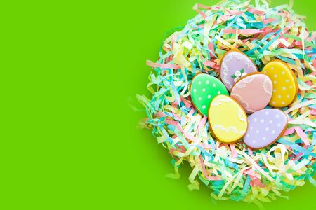 Sweets for celebrate Easter. Gingerbread in shape of easter bunny and easter eggs. White and color background top view copy spaceの写真素材
