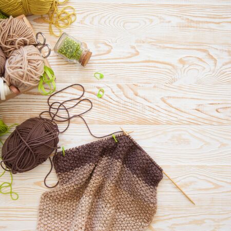Woolen knitted fabric from yarn. Turquoise old aged new background. Black coffee and chocolate.