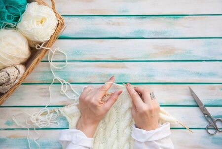 Woolen knitted fabric from yarn. Turquoise old aged new background. Black coffee and chocolate.の写真素材