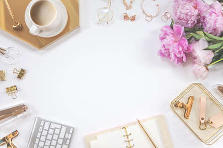 Concept female work or blogging. Gold and white stationery. Feminine space for work and creativity.の写真素材