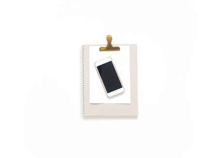 Flat lay, top view office table desk. Workspace with blank clip board, office supplies, pencil, telephone and cup of tea on white background.の写真素材