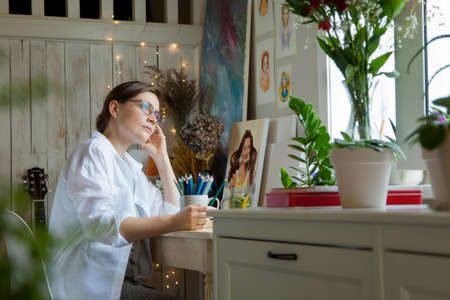 Artist Creative Designer Illustrator Graphic Skill Concept. On the table are brushes, paints, sketchbooks, and blank canvases. Workplace.の写真素材