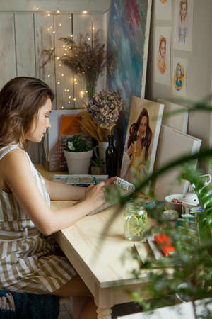 Artist Creative Designer Illustrator Graphic Skill Concept. On the table are brushes, paints, sketchbooks, and blank canvases. Workplace.の写真素材