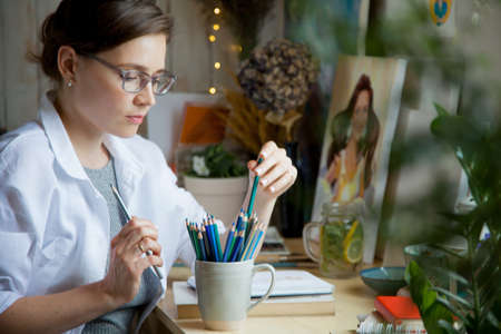 Artist Creative Designer Illustrator Graphic Skill Concept. On the table are brushes, paints, sketchbooks, and blank canvases. Workplace.の写真素材