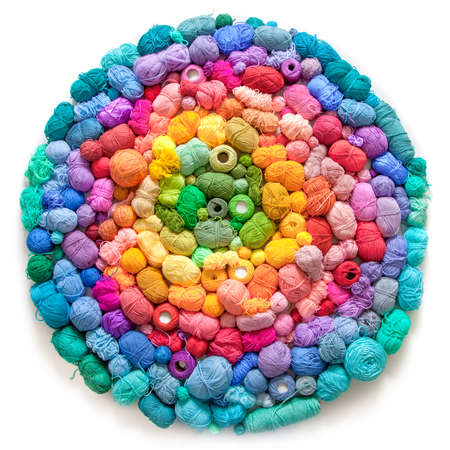 Colored balls and skiens of yarn for knitting. Top view. Rainbow colors. Color radial, round...