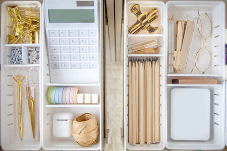 Female white workplace. A method for storing stationery neatly. Stylish gold pens, stapler, glasses,...