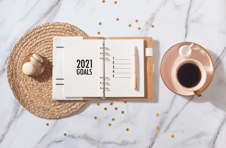 New Year Resolution Goal List 2020 - Business office desk with notebook about plan listing of new year goals and resolutions setting. Change and determination concept.の写真素材
