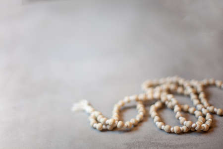 Top view white rosary beads isolated on the grey backgroundの写真素材