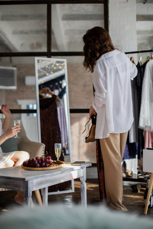Fashionable brunette woman try on evening long black sparkle dress at showroom wardrobeの写真素材