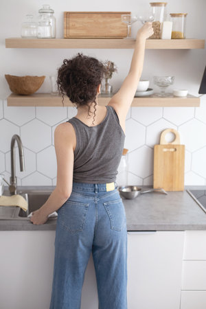 Comfortable white gray kitchen interior open box full of various crockery porcelain or glass plates