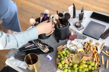 Closeup hands makeup artist applying liquid foundation mixing colors skin tone complexion