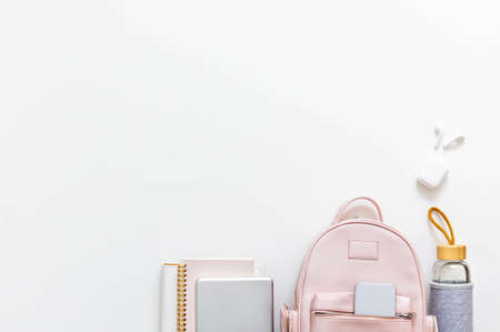 Top view elegant pink student backpack full of supplies isolated. Back to school concept