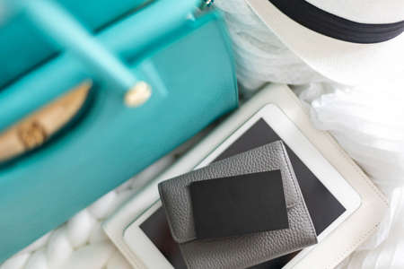 Top view female leather wallet with business card mock up on white knitted plaid identity branding