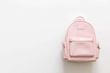 Elegant leather pink female backpack isolated on white background with copy space top view. Stylish bag with zipper and pocket for carrying college or university supplies. Back to school conceptの写真素材