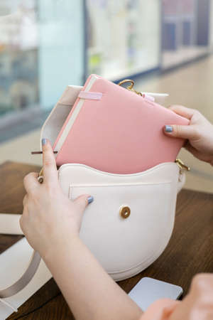 Top view business female hands pulling out pink notepad diary pen ready to formal meeting or work