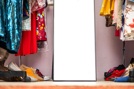 Modern clothes rack full of fashionable apparel and shoes closeup clothing and accessories storageの写真素材