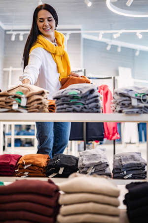Modern woman choosing clothes at fashionable store boutique discount enjoying leisure hobbyの写真素材
