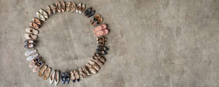 Top view many colored female shoes on gray floor footwear wheel fashion stylish footgear choosingの写真素材