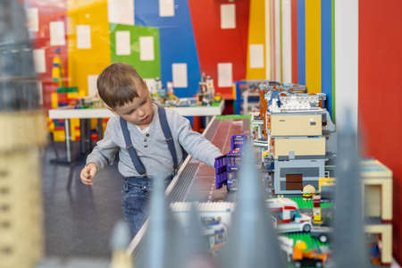 Little boy plays color Lego set on the table. Early training and development.のeditorial素材