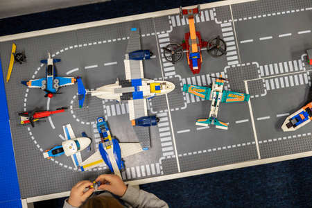 Little boy plays color Lego set on the table. Early training and development.のeditorial素材